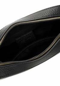 Black leather pouch with a textured exterior, gold metal zipper, and a smooth black lining. Features an interior slip pocket for organization.