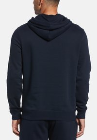 Navy blue hooded sweatshirt with a soft texture, long sleeves, and a ribbed hem. Features a kangaroo pocket and adjustable drawstring hood.