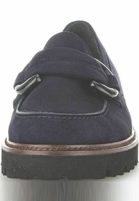 Mocassino in suede blu navy con un design cucito, doppie cinghie e una suola piatta in gomma texturizzata. Presenta eleganti accenti in metallo nero.