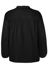 Blusa nera con maniche lunghe, motivo a pois testurizzati, scollatura arricciata e dettaglio sul retro arricciato. Tessuto morbido con una vestibilità ampia.