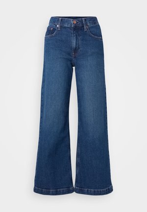 Jeans de ganga de perna larga em azul escuro, com cintura alta, design de cinco bolsos e barras dobradas. Textura suave com detalhes de costura discretos.