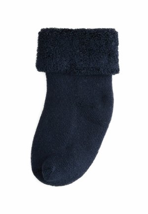 Marineblaue Socke mit einem strukturierten, flauschigen Bündchen und glattem Körper. Strickmaterial mit einer runden Spitze, designed für Wärme und Komfort.