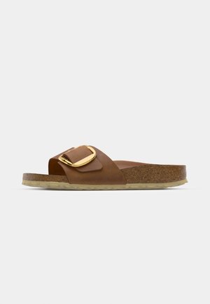 Brown leather slide sandal with a wide strap and gold-tone buckle. Features a cork footbed and a textured rubber sole.