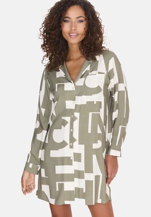 Green and white patterned shirt dress with long sleeves, collar, front buttons, and chest pocket. Abstract design covers the fabric.