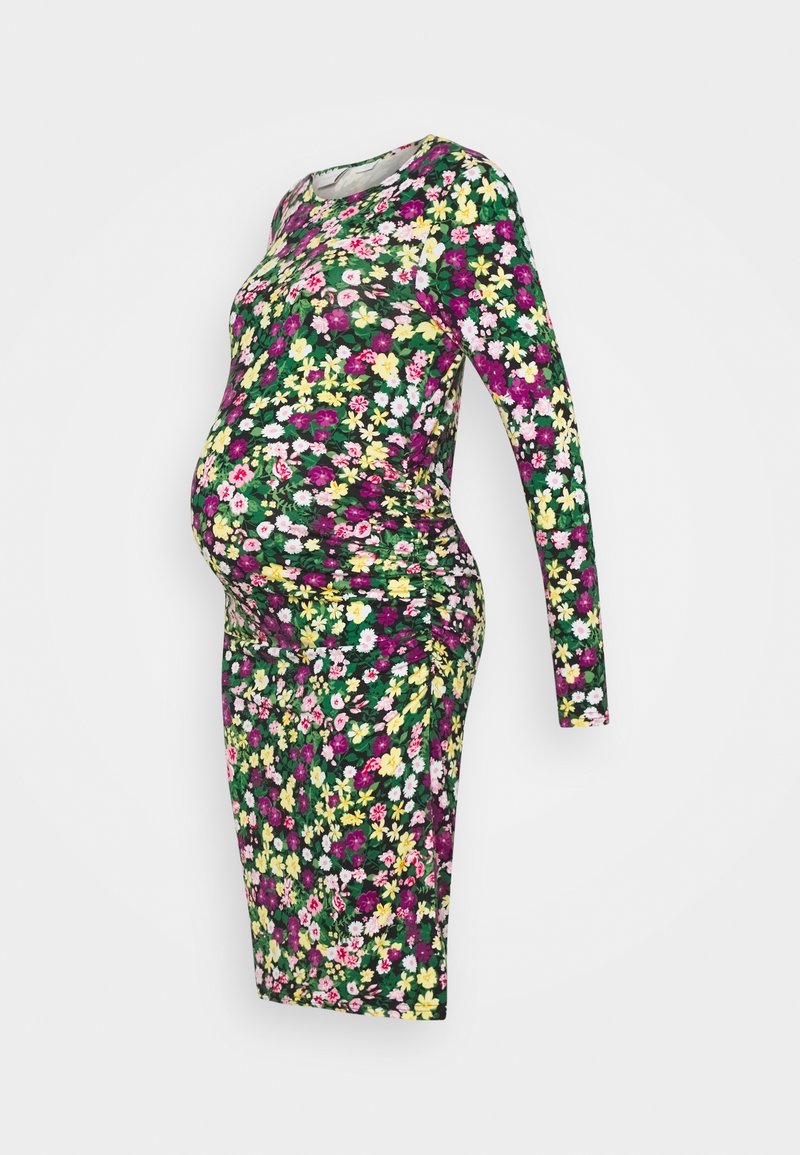 Maternity dress in floral print. Features long sleeves, round neckline, stretchy fabric, and a fitted silhouette accentuating the belly.