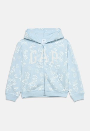 Light blue zip-up hoodie with white floral and seashell patterns and large "GAP" letters on chest, featuring front pockets and a hood.