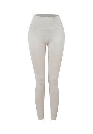 Beige naadloze leggings met hoge taille, brede geribde tailleband en een smalle pasvorm tot aan de enkels.