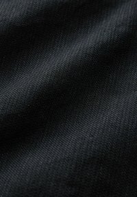Black textile with a smooth, woven texture; exhibits fine, consistent patterning across the surface. No visible accents or hardware.