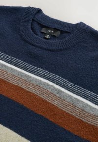 Navy blue knit sweater with horizontal stripes in brown, gray, white, and a light beige. Features a crew neckline and soft texture. Brand tag visible.