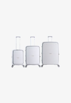 Set of three white hard-shell suitcases, varying in height, with textured surfaces, telescoping handles, and smooth-rolling wheels.