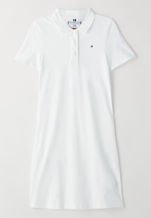 Hvid polo kjole lavet af glat bomuld. Har en tre-knaps lukning og et lille logo på venstre bryst. Korte ærmer, normal pasform.