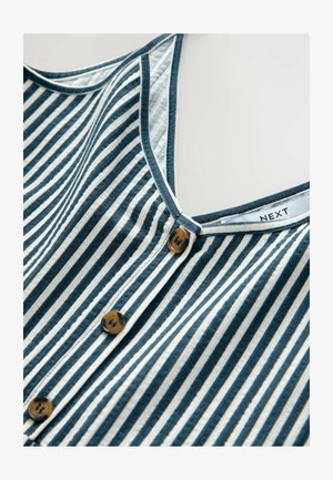 Zirga sleveļu krekliņš tumši zils un krēmkrāsas svītrās, ar dziļu apkakli un trim brūnām pogām gar priekšpusi. Uz etiķetes rakstīts "NEXT."