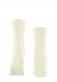 Calzini in misto cotone di colore bianco sporco. Fasce a coste in cima, texture liscia, design semplice, con etichetta della taglia stampata sul lato.