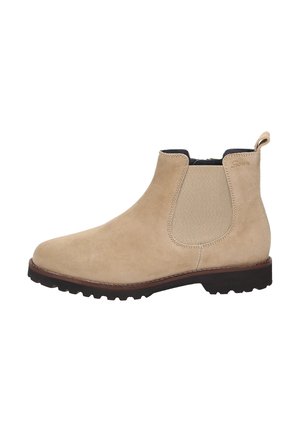 Botte cheville en suède beige avec des panneaux élastiques sur les côtés, bout rond et semelle en caoutchouc texturé. Équipée d'une languette au talon pour un enfilage facile.