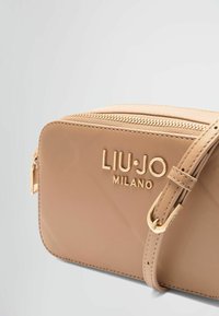 Smeđi kožni crossbody torba s zlatnim hardverom, s patentnim zatvaračem i utisnutim logotipom. Glatka tekstura s pravokutnim oblikom.