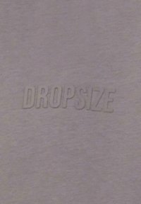 Purple fabric with a smooth texture features embossed text "DROPSIZE" in a slightly darker shade, centrally positioned.