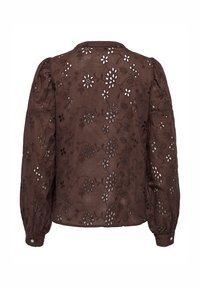 Braune bestickte Bluse mit Puffärmeln, verziert mit floralen Ausschnitten und einem strukturierten Stoff. Mit geknöpften Manschetten und abgerundetem Kragen.