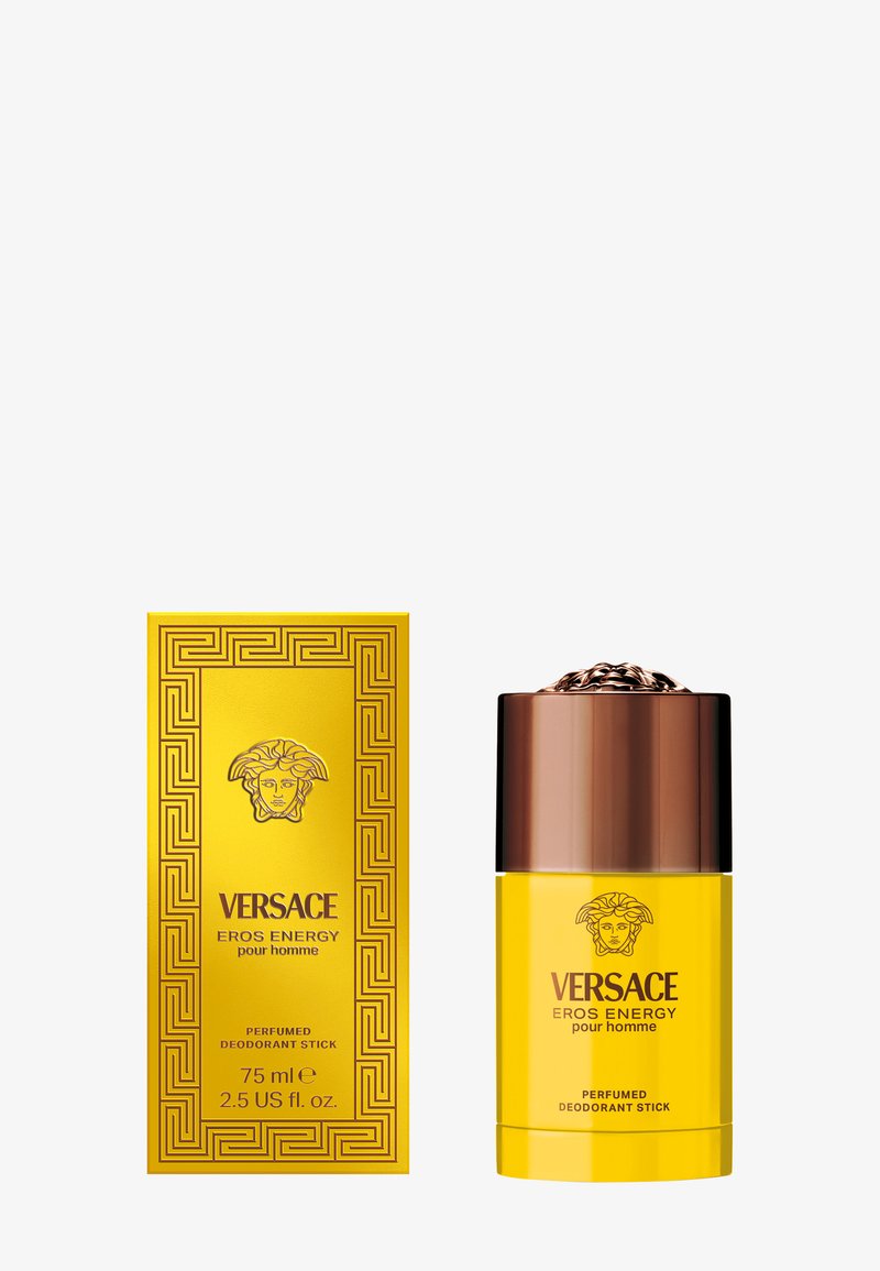 Gelber Deodorant-Stick und passende Verpackung mit goldgeprägtem Medusa-Logo und griechischem Schlüsselmuster. Der Stick hat eine braune metallische Kappe.