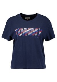 Navy blue cotton t-shirt, cropped design, featuring "TOMMY JEAN" logo in red, white, and blue stripes, round neckline, short sleeves.