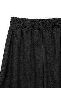 Pantaloni neri in lino con cintura elastica arricciata, caratterizzati da una texture morbida e design a gamba larga. Adatti per un abbigliamento casual.