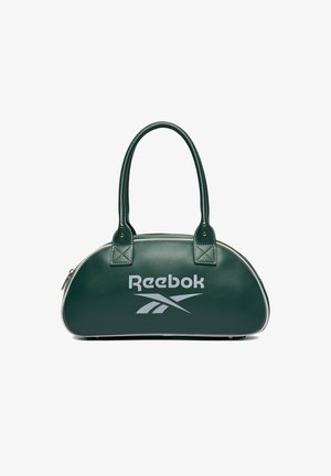 Ciemnozielona torebka Reebok o zaokrąglonym kształcie, z dwoma uchwytami, białym logo i zamkiem błyskawicznym, na białym tle.