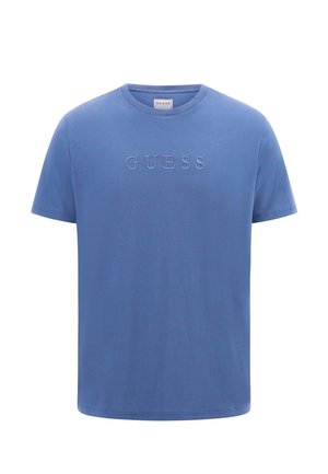 T-shirt en coton bleu à manches courtes, avec un logo "GUESS" en relief sur le devant. Encolure ronde, texture lisse, coupe décontractée.