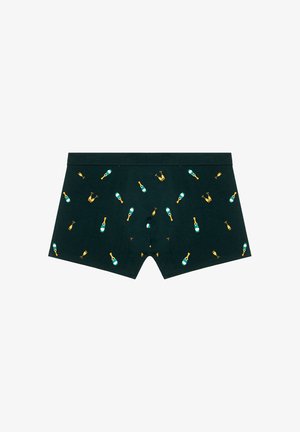 Boxers en tissu vert foncé présentant un motif répété de bouteilles de champagne et de verres dans des couleurs jaunes et teal.