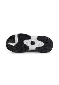 Semelle de chaussure de sport en noir et blanc avec un profil en caoutchouc à motifs, surface texturée et accents circulaires. Comprend des rainures prononcées pour une meilleure traction.