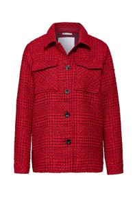 Red, textured jacket with a checkered pattern, featuring two chest pockets and black buttons. Structured collar and long sleeves.