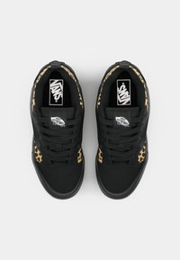 Sorte joggesko med leopardmønstrede detaljer på sidene, med snøring, polstret krage og Vans-logo på tungen.
