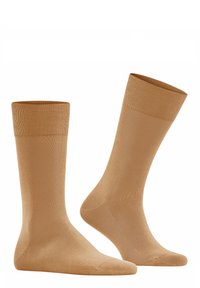Chaussettes en coton beige avec des bordures côtelées, texture lisse et zone de orteil renforcée ; hauteur moyenne, adaptées à un usage décontracté ou formel.