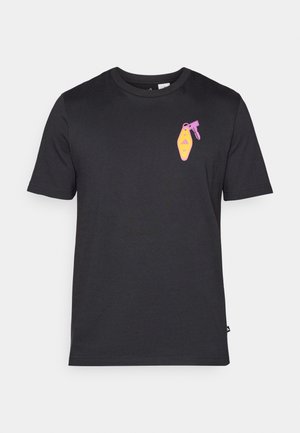 Black cotton t-shirt with short sleeves featuring a colorful graphic of a shoelace detail on the left chest area.