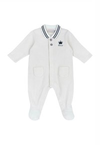 Barboteuse pour bébé blanche côtelée avec un col rayé bleu marine, deux poches sur le devant et une petite broderie de couronne. Caractéristiques : boutons-pression et design avec pieds.