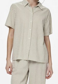 Short-sleeve, button-up shirt in light beige with darker beige vertical stripes, featuring a spread collar and a relaxed fit.
