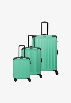 Drei Hartschalenkoffer in Mintgrün mit geribbeltem Design, schwarzen Akzenten, ausziehbaren Griffen und vier Rädern für Mobilität.