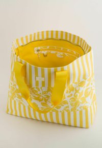 Geel draagtas met een bloemen- en gestreept patroon. Glad materiaal, met een ritsvak aan de binnenkant en stevige gele handvatten.