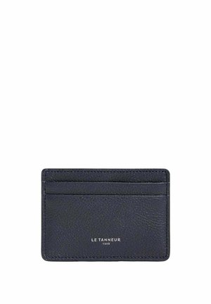Navy leather cardholder with textured finish, four slots, and embossed logo. Compact rectangular shape, minimalistic design.