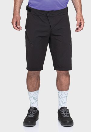 Schwarze Shorts mit einer Länge bis zur Mitte des Oberschenkels, ausgestattet mit Reißverschlusstaschen, einem Knopfverschluss und einem strukturierten Design an den Taschenakzenten.
