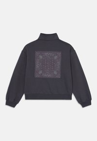 Dark gray sweatshirt with a high neck and ribbed cuffs, featuring a square botanical pattern printed on the back. Soft texture.