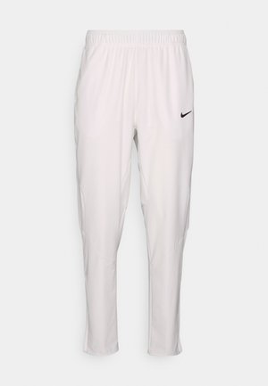 White athletic pants with an elastic waistband. Features a slim fit, smooth texture, and a small black Nike logo on the front.