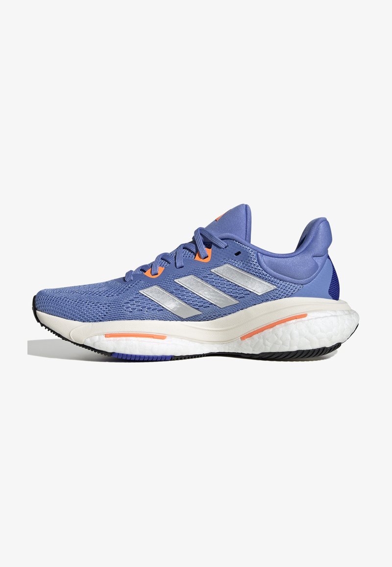 Blue athletic shoes with mesh upper, silver stripes, and orange accents. Curved white midsole and black rubber outsole for traction.