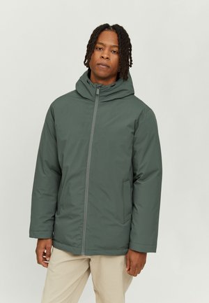 Green padded jacket with a hood, front zipper, and side pockets. Constructed from water-resistant material, featuring a smooth texture.