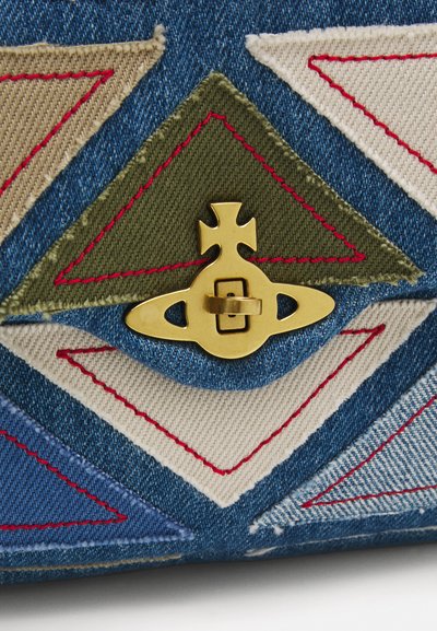 Denim bag featuring multicolored triangular fabric patches in beige, green, and blue, with red stitching and a gold clasp as a notable detail.