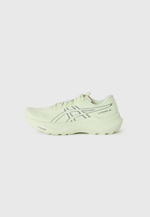 Light green running shoe with a textured upper, padded collar, and reflective accents. Features a thick outsole and perforated detailing.