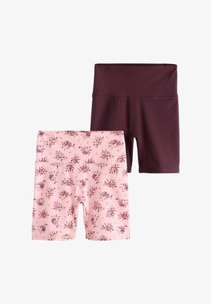 Two pairs of high-waist biker shorts, one solid dark burgundy and one light pink with small floral print.