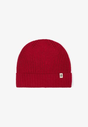 Red knit beanie with a ribbed texture and a folded brim. Features a small branded tag on the side.