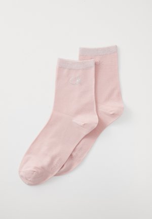 Pink cotton socks with a ribbed cuff and subtle logo. Smooth texture, standard ankle length, and plain design without patterns.