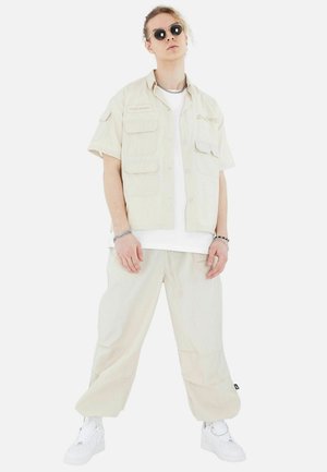 Megaman FREIZEI SET - Trousers - beige