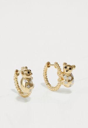 Guldøreringe med et bjørne-design, besat med små klare sten, med en snoet rebstruktur og buet form.