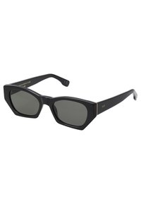 Occhiali da sole neri a forma esagonale con lenti grigie, caratterizzati da una finitura opaca, dettagli dorati sulle asticelle e un design leggero e moderno.
